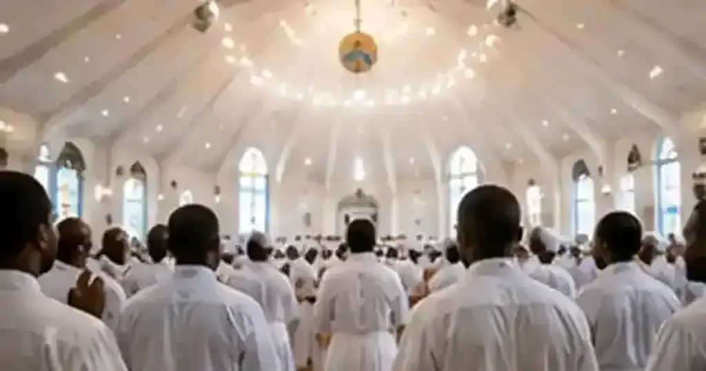 Celestial Church congregation in white prayer garments worshipping in a bright sanctuary